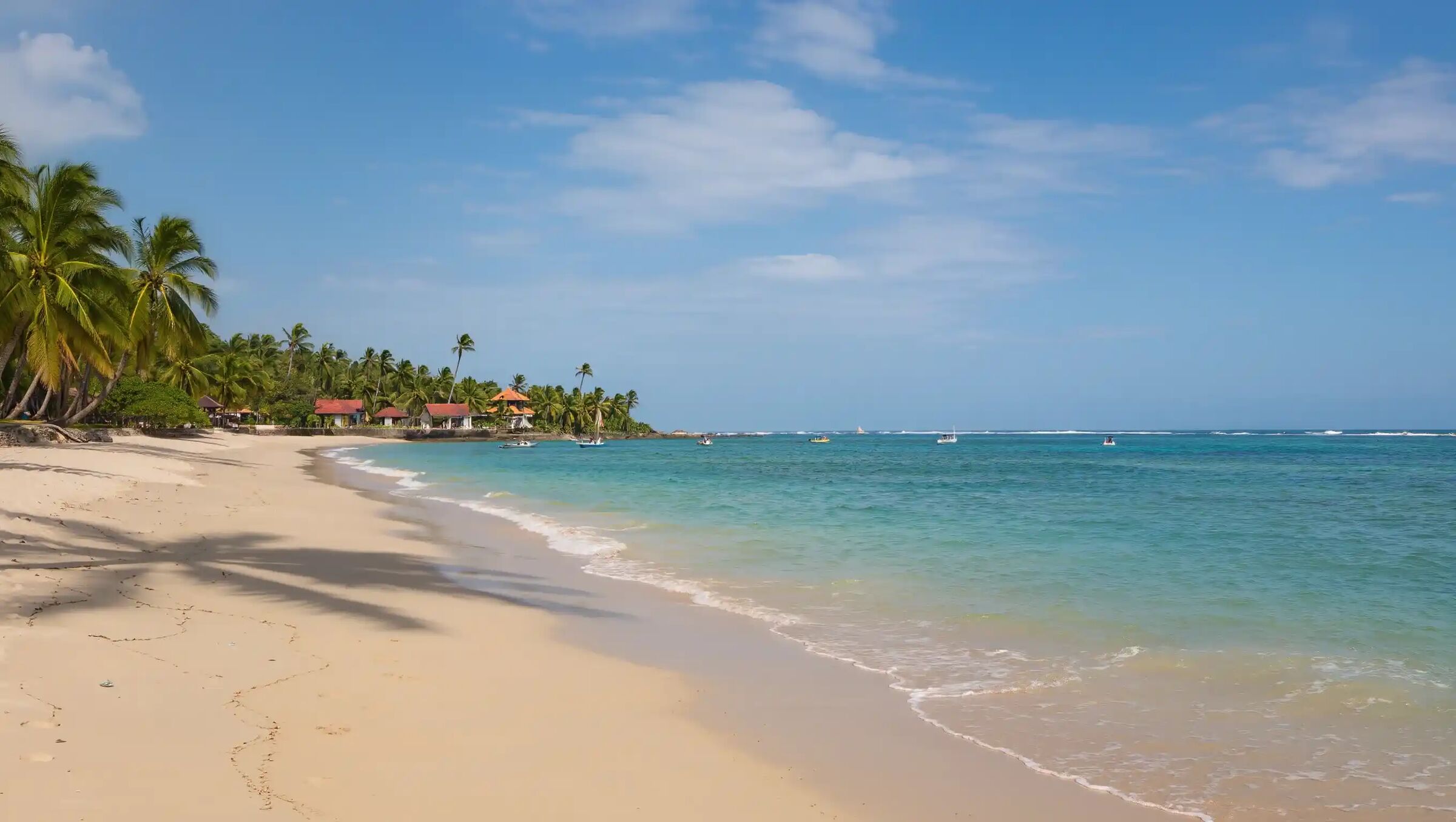 Calm white-sand beach and shallow turquoise water on Bali's south-east coast