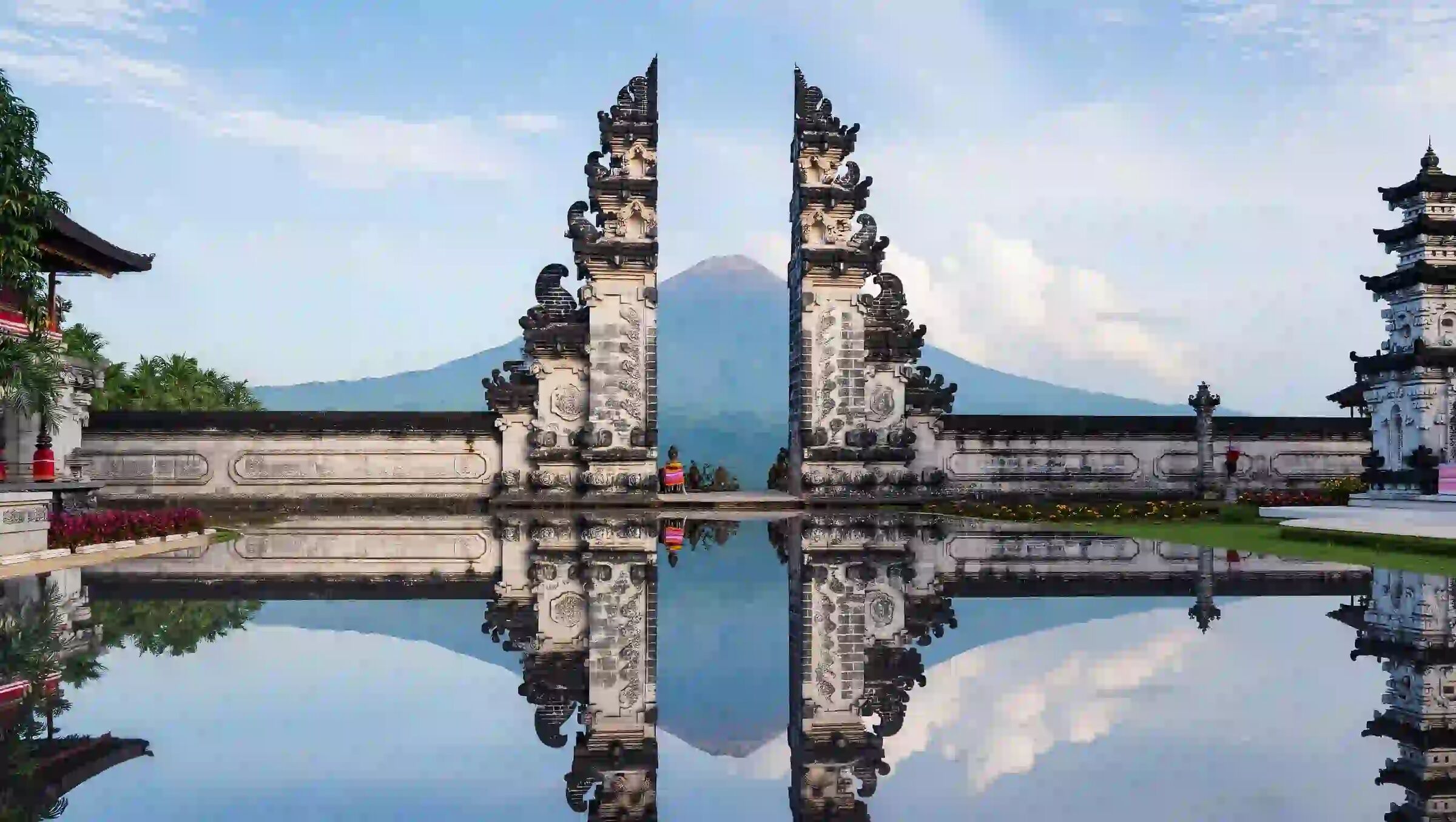 Split gate of Pura Lempuyang framing Mount Agung, reflected in still water