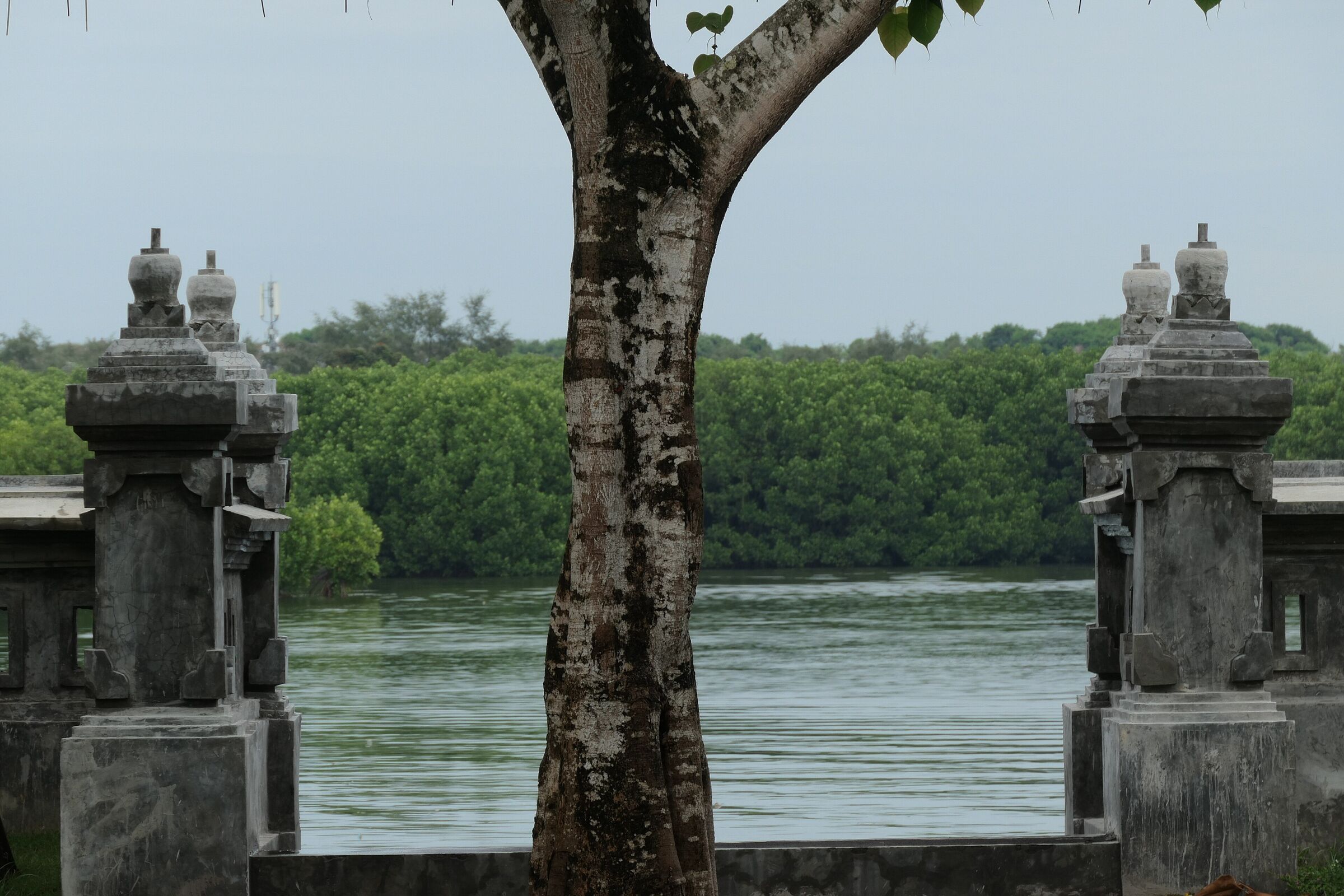 Temple gate pillars at Pura Sakenan looking across the channel to the mangroves of Serangan