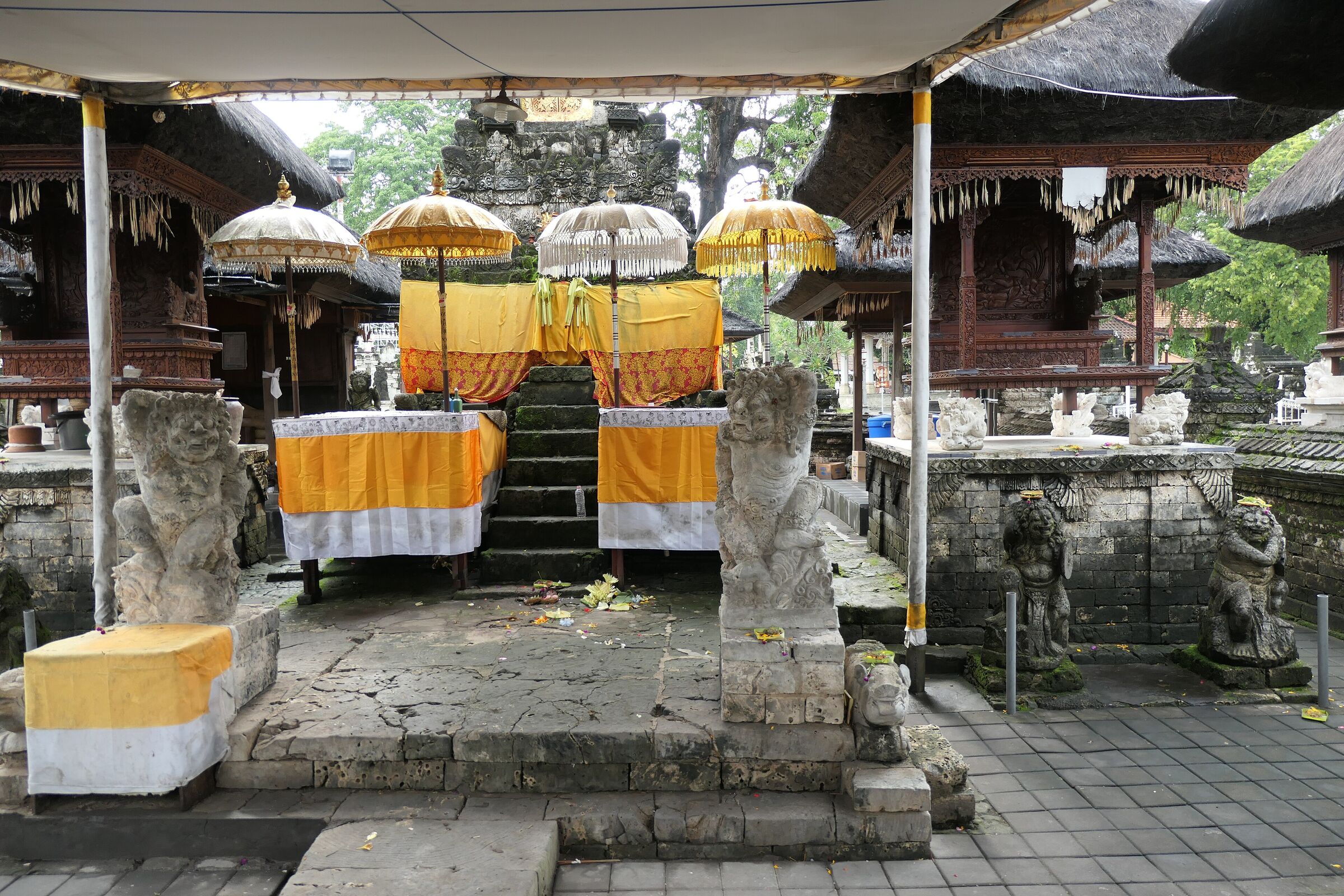 Shrines dressed with yellow cloth and ceremonial umbrellas at Pura Sakenan